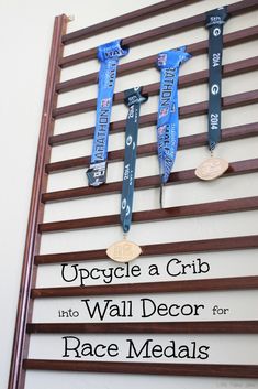 three medals hang on a wall with the words upcycle a crib into wall decor for race media