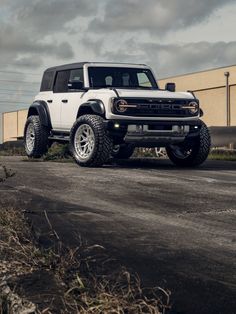 a white truck parked on the side of a road