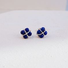 Lapis Lazuli Earrings Gemstones Studs These dainty Lapis Lazuli beads have been wrapped onto Sterling Silver posts in a unique design, with Sterling Silver wire and made diamond shape that sits beautifully on the ear.  Great for everyday or stack with other earrings. Lapis Lazuli is the birthstone of September Lapis Lazuli is a classical gemstone which is thought to be a protection stone, bringing confidence and clarity of mind and peace. Details: Size: 4mm Materials: Genuine Lapis Lazuli Beads, Adjustable Lapis Lazuli Earrings As Gift, Adjustable Lapis Lazuli Earrings For Gift, Elegant Lapis Lazuli Wire Wrapped Earrings, Elegant Wire Wrapped Lapis Lazuli Earrings, Lapis Lazuli Earrings, Lapis Lazuli Beads, Birthstone Earrings, Gemstone Stud Earrings, Birthstone Earring