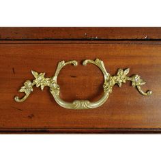 an ornate wooden drawer with brass handles