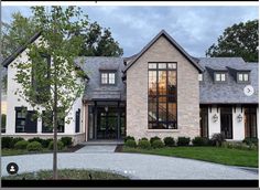 a large house with lots of windows and landscaping