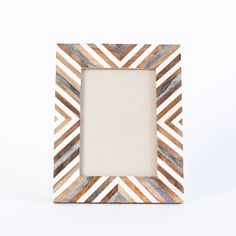 a white and brown photo frame sitting on top of a table