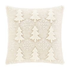 a white pillow with pine trees on the front and back, made out of knitted fabric