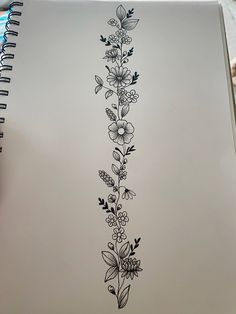 an open notebook with flowers and leaves drawn on it