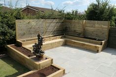 an outdoor garden with wooden planters and benches