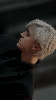 a person with white hair and black shirt