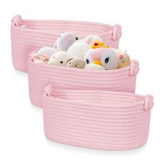 two pink storage baskets filled with stuffed animals