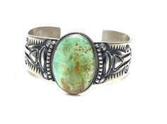 Native American Navajo handmade Sterling Silver Turquoise cuff bracelet * Native American handmade * Navajo Tribe * Sterling Silver heavy gauge Satin vintage finish * Stone: Carico green Turquoise * Width: 1 1/4 inch * Length: 6 3/4 inch * Slightly adjustable * Signed For more information regarding this piece or any questions you may have please feel free to message us. Thank you! Handmade Southwestern Green Cuff Bracelet, Vintage Turquoise Bracelets With Inlay, Navajo Tribe, Southwestern Style Hand-strung Blue Bracelet, Southwestern Turquoise Hand-strung Bracelets, Vintage Turquoise Hand-tooled Bracelets, Vintage Nickel-free Turquoise Cuff Bracelet, Turquoise Bracelet Cuff, Turquoise Cuff