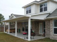 a covered patio in front of a house