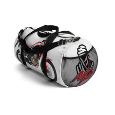 a white duffel bag with red and black designs on the front, featuring an image of a motorcycle