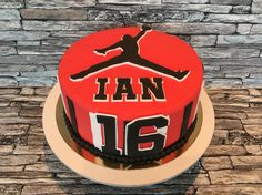 a red and black cake with the number 16 on it