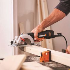 a man using a circular saw to cut wood with a cordless jig tool