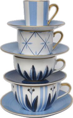 four cups and saucers stacked on top of each other