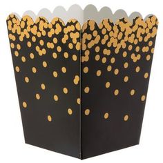 an open black and gold paper box with polka dots on the inside, sitting in front of a white background