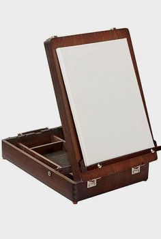 an open wooden box with a mirror inside