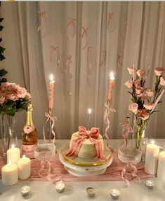 the table is set with candles, flowers and a cake on it's side