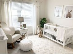 a baby's room with white furniture and pictures on the wall