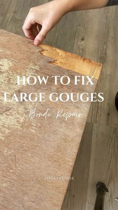 a person holding a piece of wood with the words how to fix large gouges on it