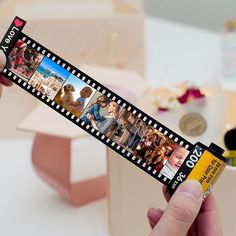 a person holding up a film strip with pictures on it