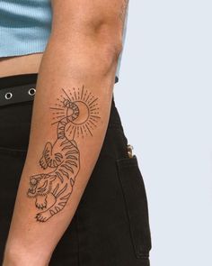 a person with a tiger tattoo on their arm