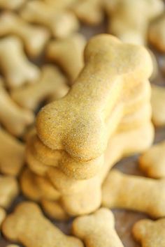 a dog bone shaped cookie sitting on top of a table next to other dogs bones