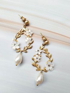 The wedding earrings are a wonderful combination of pave set crystals and pearls set into a nature inspired floral design. The design coordinates exceptionally well with patterns in many lace gowns. The Earrings are handmade and decorated with natural mother-of-pearl flowers, Swarovski crystals, Swarovski pearls. Carefully handmade to add a special touch of decadence to your special day. Gorgeously packaged in box to treasure always. Upon request, we can arrange express delivery for an additiona White Cubic Zirconia Flower Earrings For Wedding, Exquisite White Pearl Earrings For Weddings, Delicate White Pearl Earrings With Elegant Design, Flower-shaped Cubic Zirconia Bridal Earrings, Delicate White Flower Earrings With Cubic Zirconia, Delicate White Cubic Zirconia Flower Earrings, Exquisite Pearl Drop Bridal Earrings For Wedding, Exquisite Flower Earrings For Wedding, Exquisite Flower-shaped Earrings For Wedding