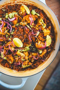 a large pot filled with lots of food on top of a table