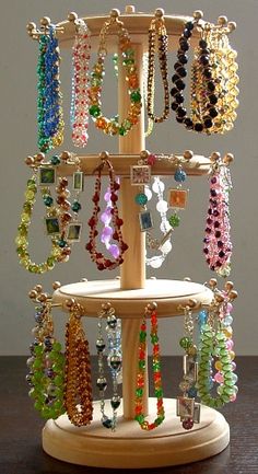 a wooden stand with several necklaces on it