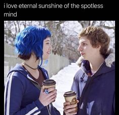 two people standing next to each other in the snow with coffee cups on their hands