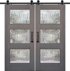 two double doors with frosted glass on each side and an iron bar at the top