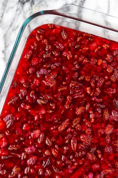 a glass casserole dish filled with cranberry sauce