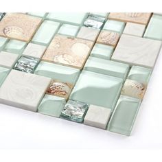 a glass mosaic tile design with various colors and designs on the back side of it