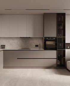 a modern kitchen with white cabinets and gray counter tops, along with a couch in the middle