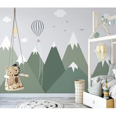 a child's bedroom with mountains and trees painted on the wall, including a teddy bear swinging from a swing