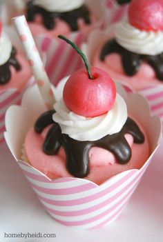 cupcakes in paper cups with chocolate and an apple on top, ready to be eaten