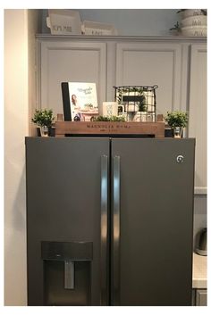 a gray refrigerator freezer sitting inside of a kitchen