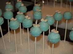 there are many blue cake pops with bows on them