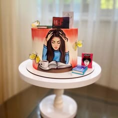 a cake decorated with a woman reading a book