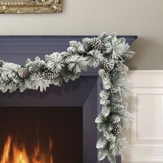 a fireplace decorated for christmas with pine cones