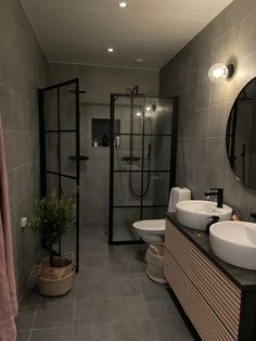 a bathroom with two sinks and a shower