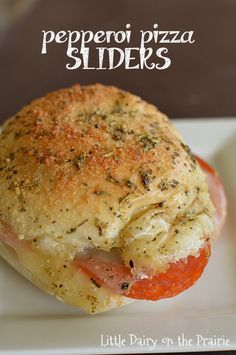 a close up of a piece of bread on a plate with the words pepperoni pizza sliders