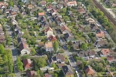 an aerial view of a neighborhood with lots of houses and trees in the foreground