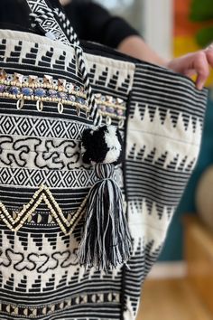 Great little black and white tote bag, that will easily take you from running errands to evenings out with the gal pals. Beautiful beaded details. Four interior pockets, one with zipper. Tote Size: 15.5" x 10.5" x 15 Black Beaded Bohemian Bags, Bohemian Black Beaded Shoulder Bag, Black And White Tote Shoulder Bag For Everyday Use, Black And White Tote Shoulder Bag For Shopping, Black And White Tote Bag For Shopping, Beaded Tote Shoulder Bag For Shopping, Black And White Travel Tote Bag, Black Bohemian Beach Bag For Shopping, Black And White Tote Bags