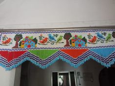 a colorful beaded curtain hanging from the ceiling above a doorway with an open door