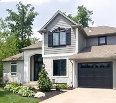 a large house with two garages in the front yard