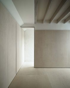 an empty room with white walls and wood flooring is seen in this image from the inside