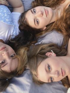 three young women laying on top of each other