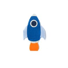 a blue and white toy with an orange nose on it's back end, sitting in front of a white background