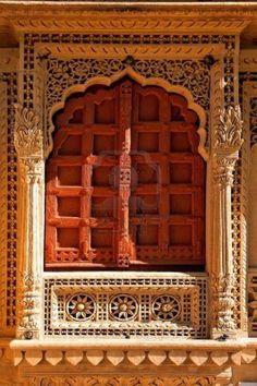 an intricately carved window in the middle of a building