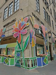 a large building with flowers painted on the front and side of it's sides